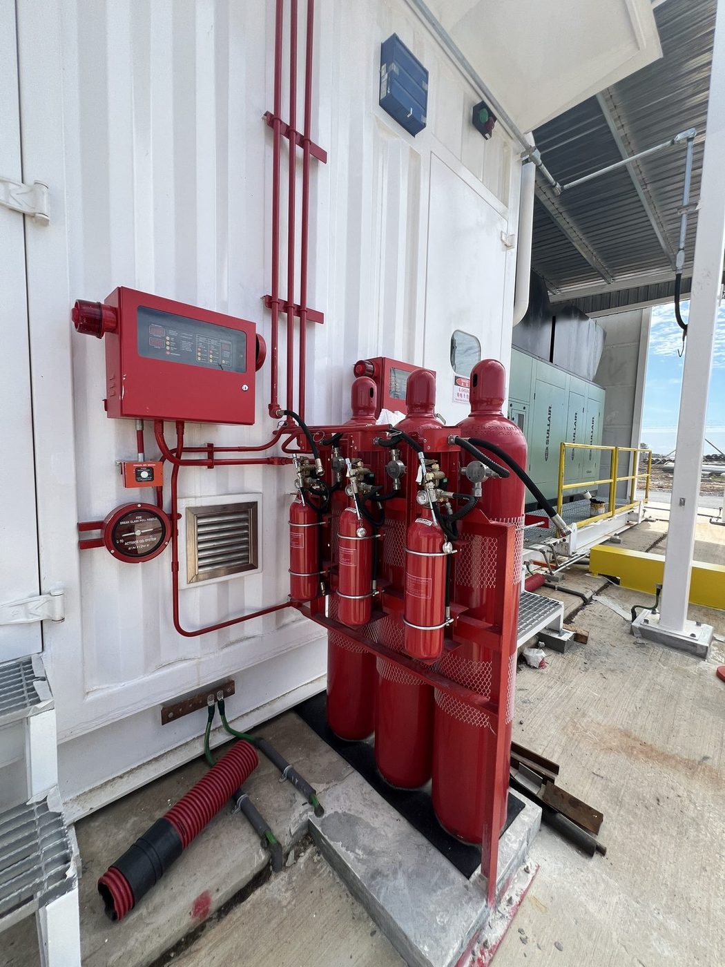 Fire suppression cylinder bank and control panel at a commercial industrial site